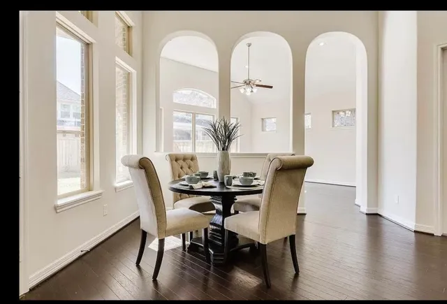 a view of a dining room with furniture window and wooden floor
