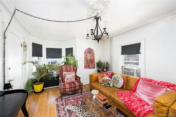 a living room with furniture and a chandelier