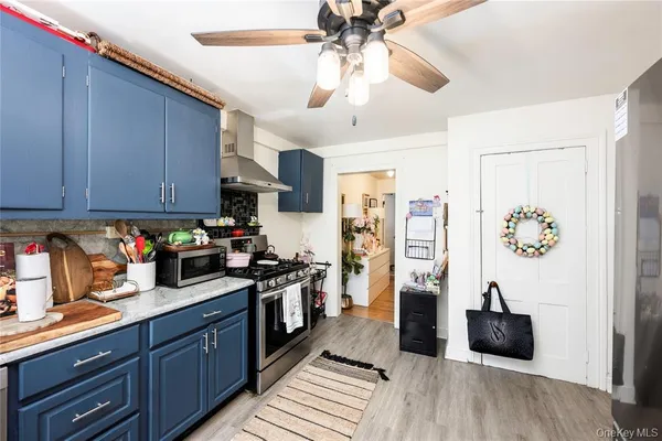 a kitchen with stainless steel appliances granite countertop a refrigerator and a stove top oven