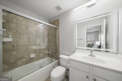 a bathroom with a sink a toilet and a mirror