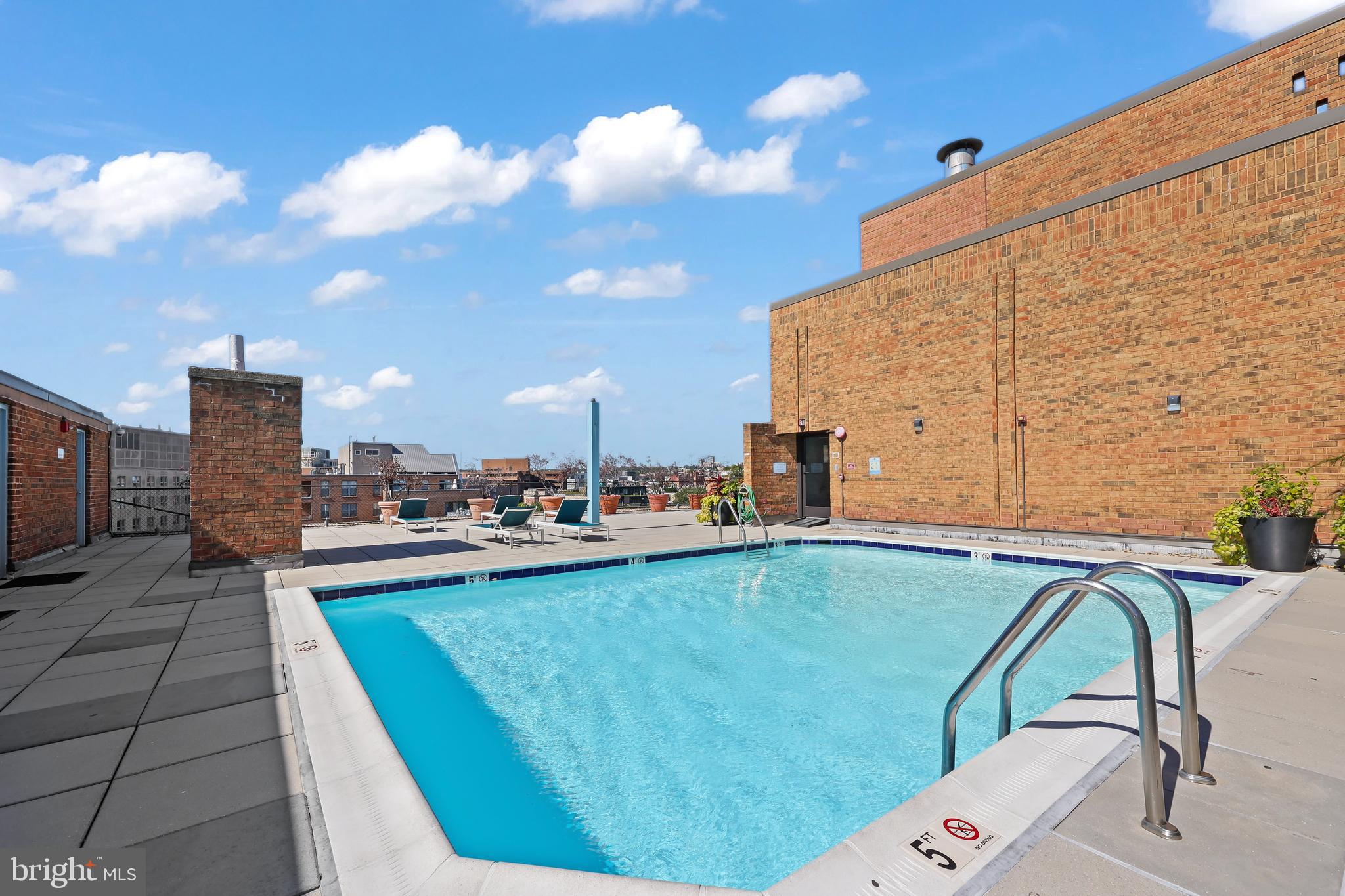 1718 P Street Northwest, Unit 509 Washington, DC 20036 - Photo 16 of 20 a view of a swimming pool with a lounge chairs