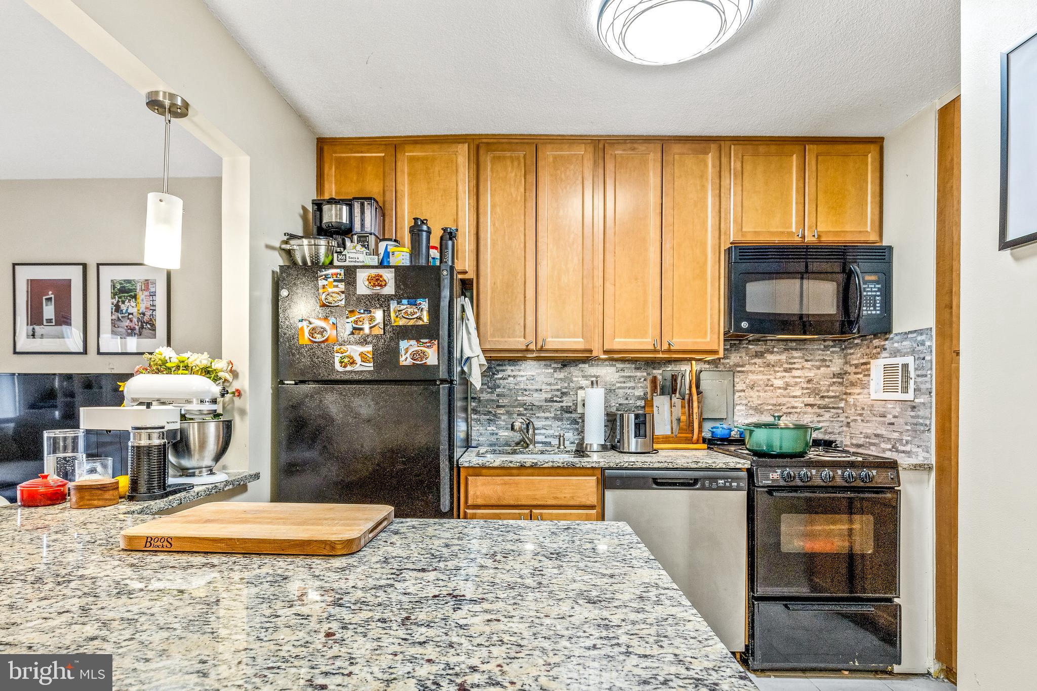 1718 P Street Northwest, Unit 509 Washington, DC 20036 - Photo 5 of 20 a kitchen with a sink and a refrigerator
