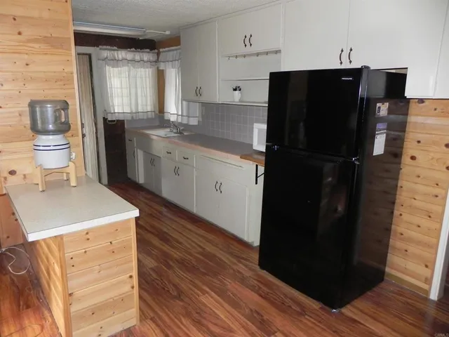 a kitchen with a refrigerator and cabinets