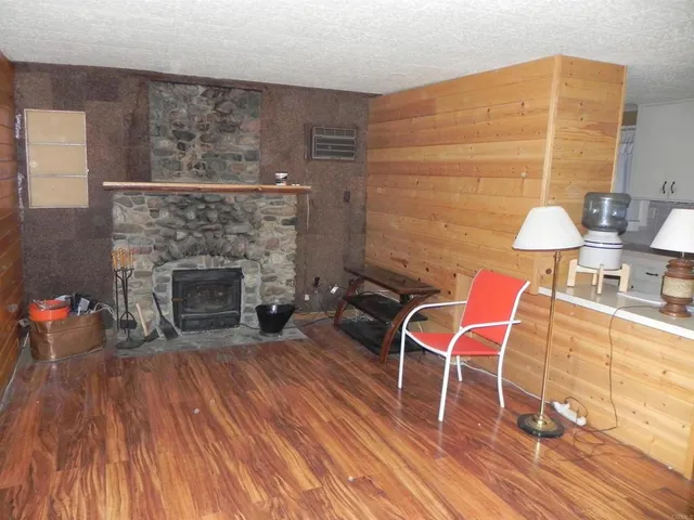 a living room with a fireplace and a wooden floor