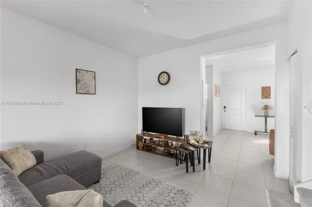 a dining room with furniture and a floor to ceiling window