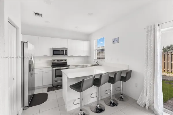 a kitchen with stainless steel appliances a refrigerator and a sink