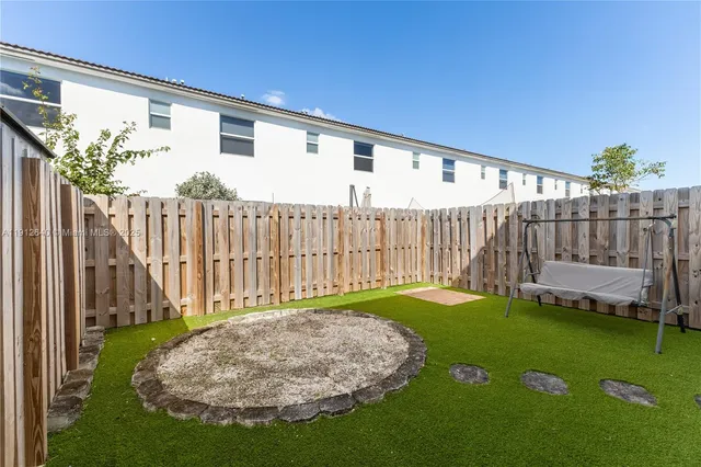 a view of backyard with a patio