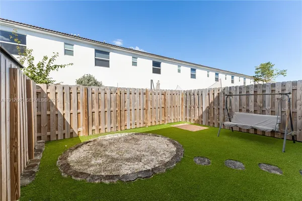 a view of backyard with a patio
