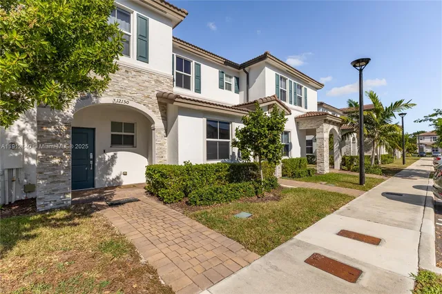 a front view of a house with a yard