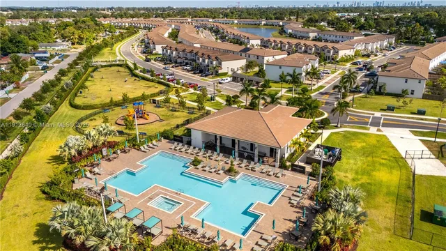 an aerial view of residential houses with outdoor space
