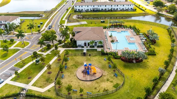 an aerial view of residential houses with outdoor space