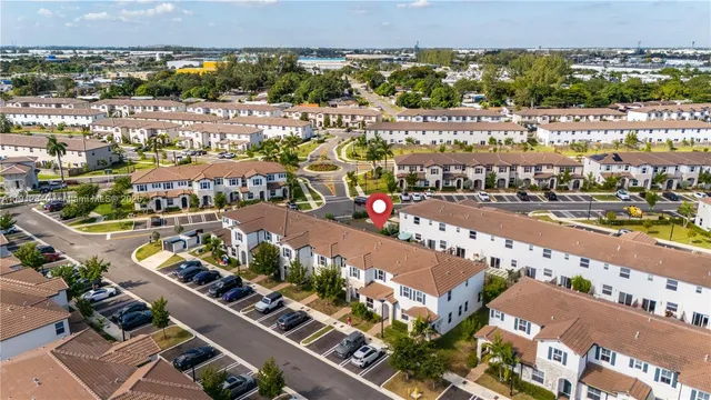 an aerial view of a house with a yard and lake view
