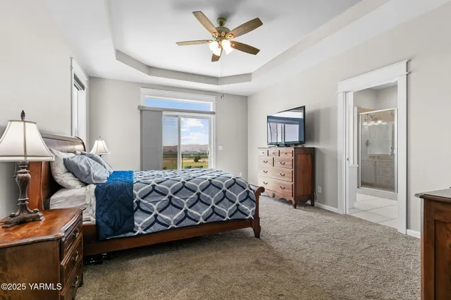 a bed room with a bed and a ceiling fan