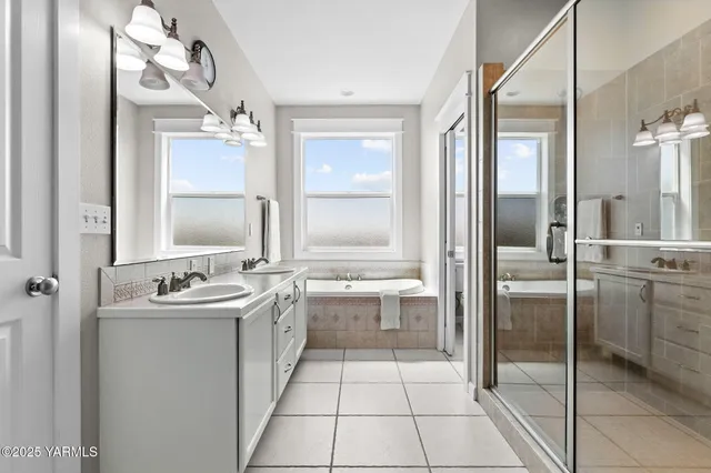 a bathroom with a tub sink and mirror