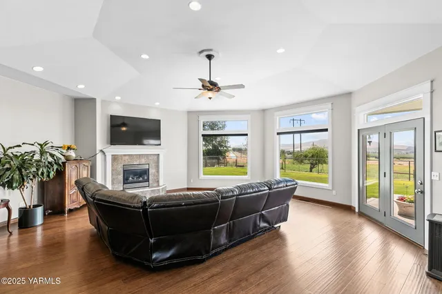 a living room with furniture fireplace and flat screen tv