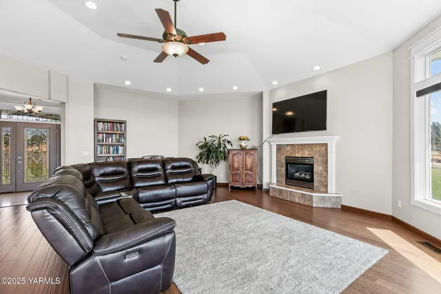 a living room with furniture a fireplace and a flat screen tv