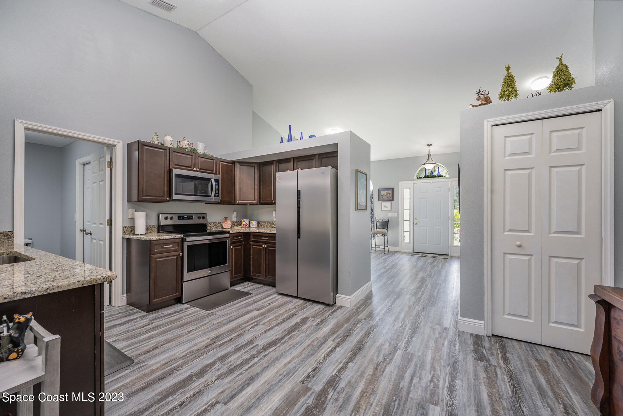 1780 Atz Road Malabar, FL 32950 - Photo 10 of 34 a kitchen with stainless steel appliances a refrigerator and a stove top oven