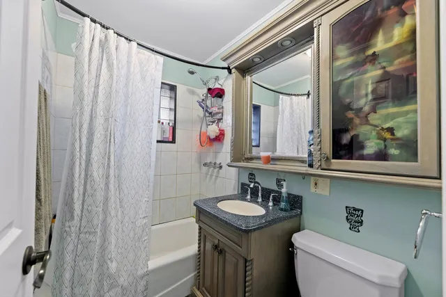 a bathroom with a sink a toilet and shower curtain