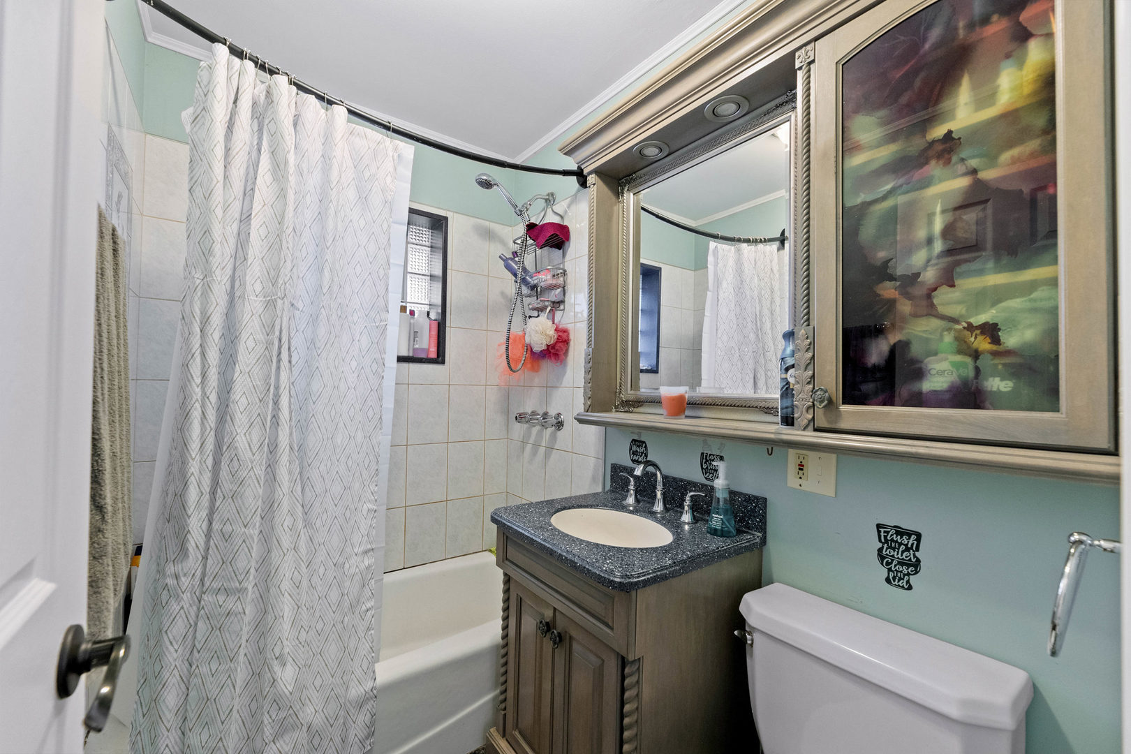 7656 80th Place Bridgeview, IL 60455 - Photo 16 of 39 a bathroom with a sink a toilet and shower curtain