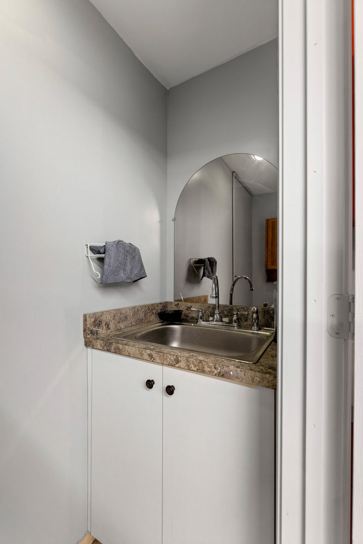 7656 80th Place Bridgeview, IL 60455 - Photo 20 of 39 a bathroom with a granite countertop sink and a mirror