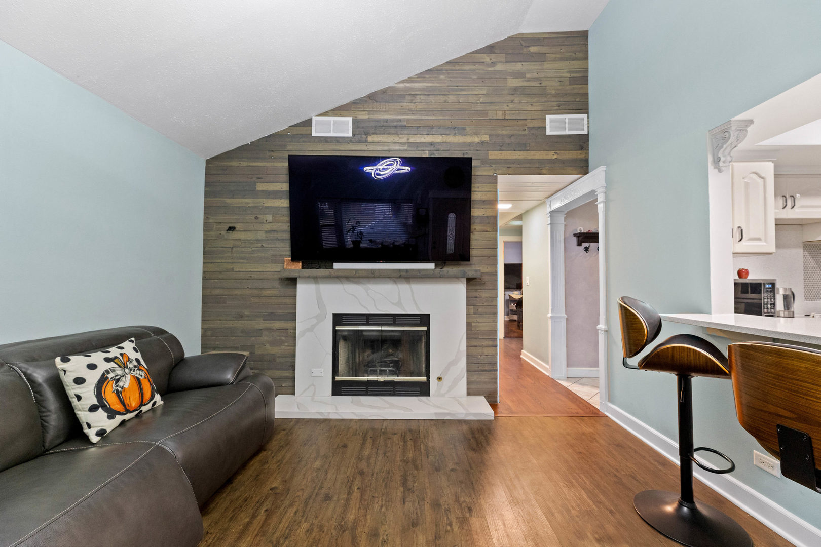 7656 80th Place Bridgeview, IL 60455 - Photo 3 of 39 a living room with furniture a fireplace and a flat screen tv