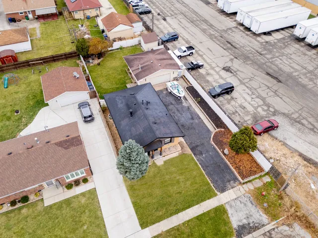 an aerial view of a house with a yard