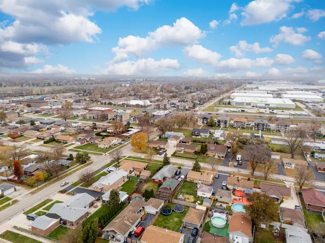 an aerial view of residential building with green space