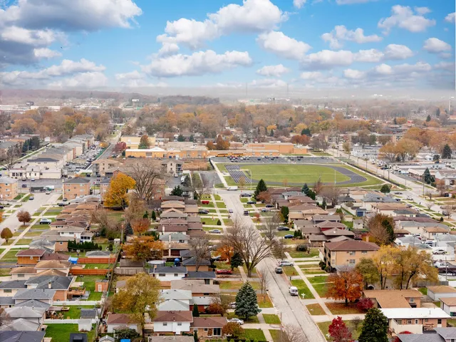 an aerial view of residential houses with outdoor space