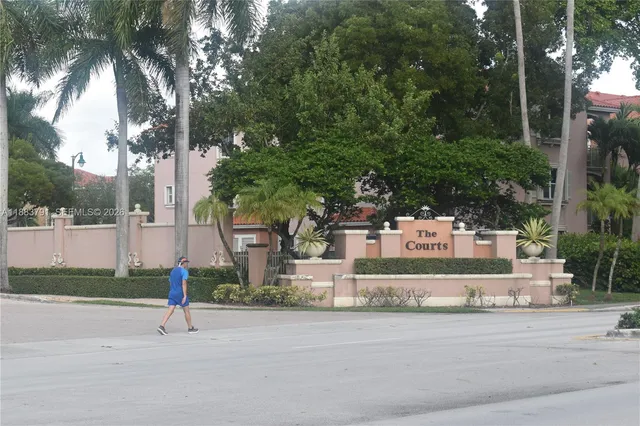 a white house that has a tree in front of it