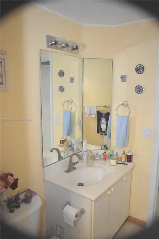a bathroom with a sink a toilet and mirror