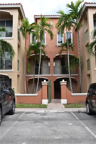 a living room with furniture and large windows