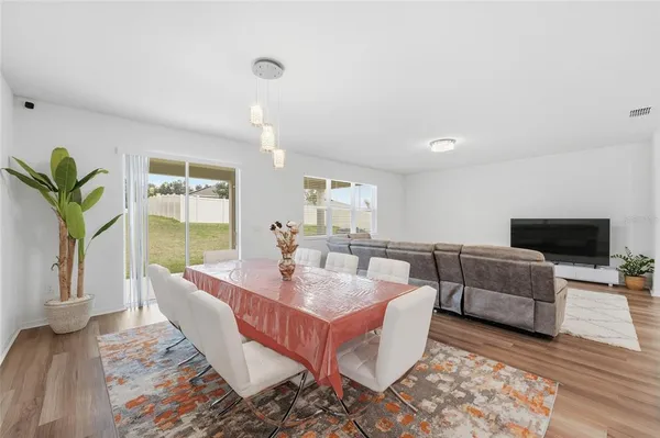 a dining room with furniture and a view of kitchen