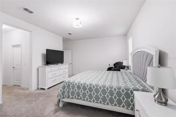 a bedroom with a bed and a dresser