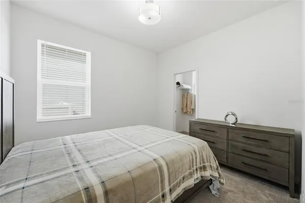 a bathroom with a granite countertop sink a toilet and a mirror