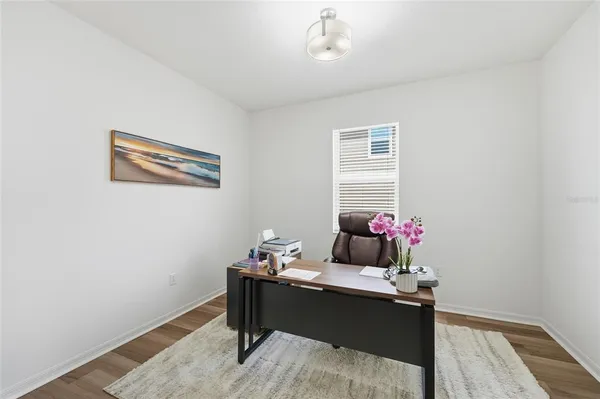 a utility room with dryer washer and shoe rack