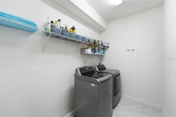 a bathroom with a granite countertop sink a mirror and a bathtub