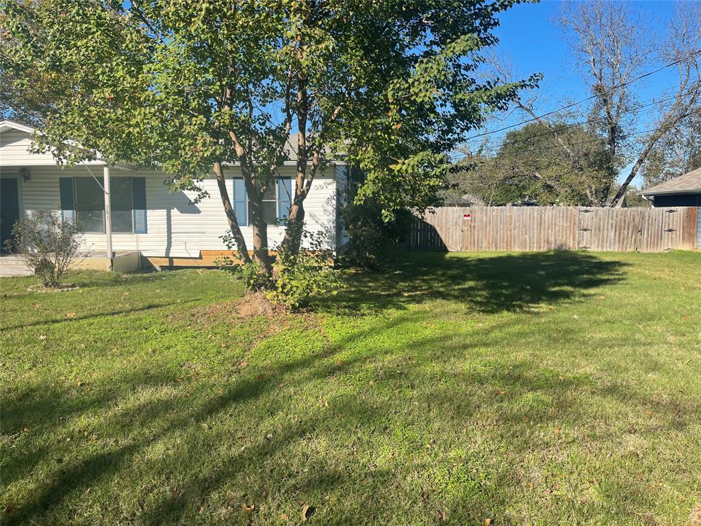 301 Walnut Street Chandler, TX 75758 - Photo 3 of 13 a view of a tree in front of a house