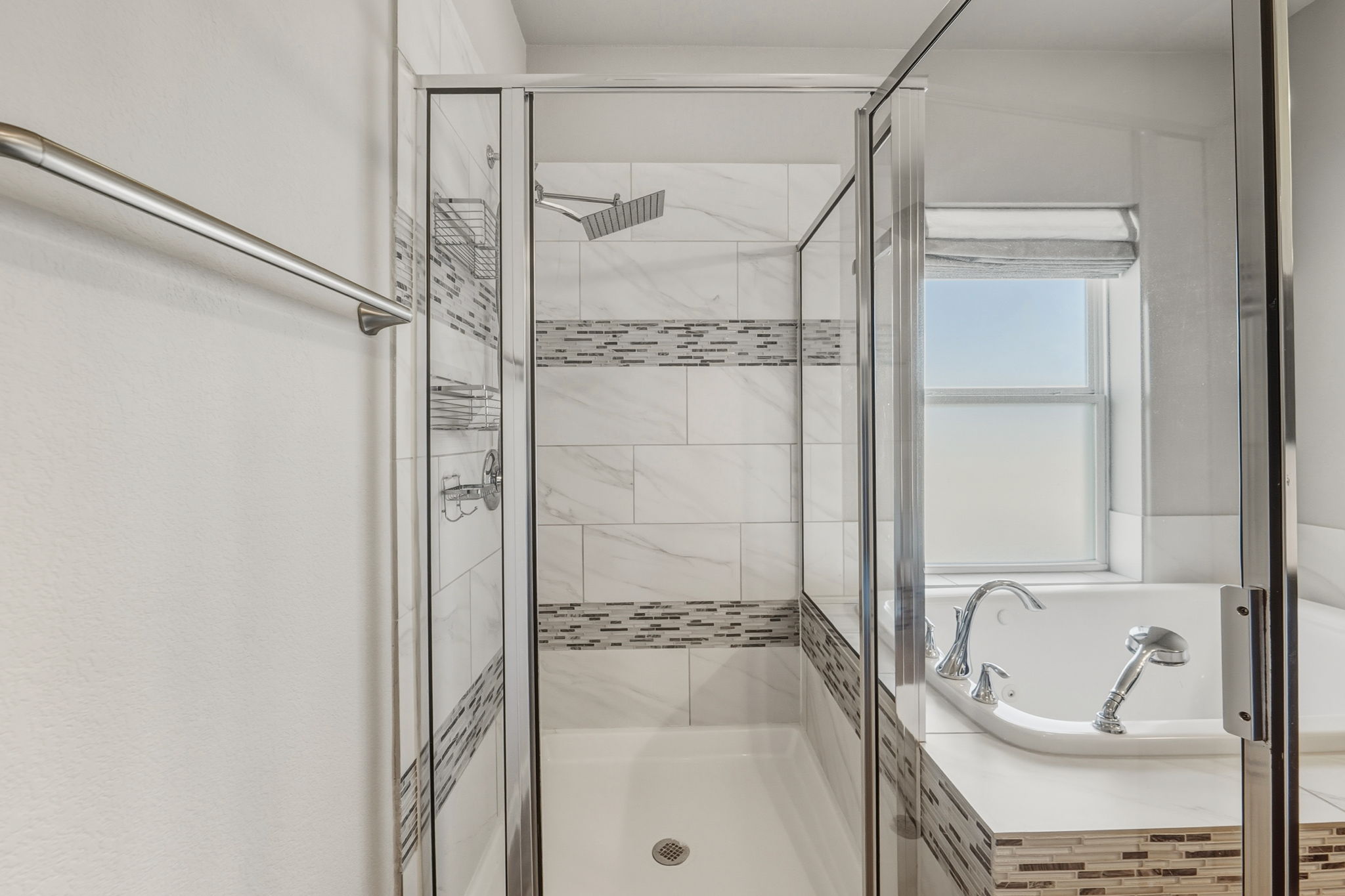 3919 Vaughan Street Austin, TX 78723 - Photo 27 of 40 A well-appointed bath features a tiled shower enclosure and a generous soaking tub with window light.