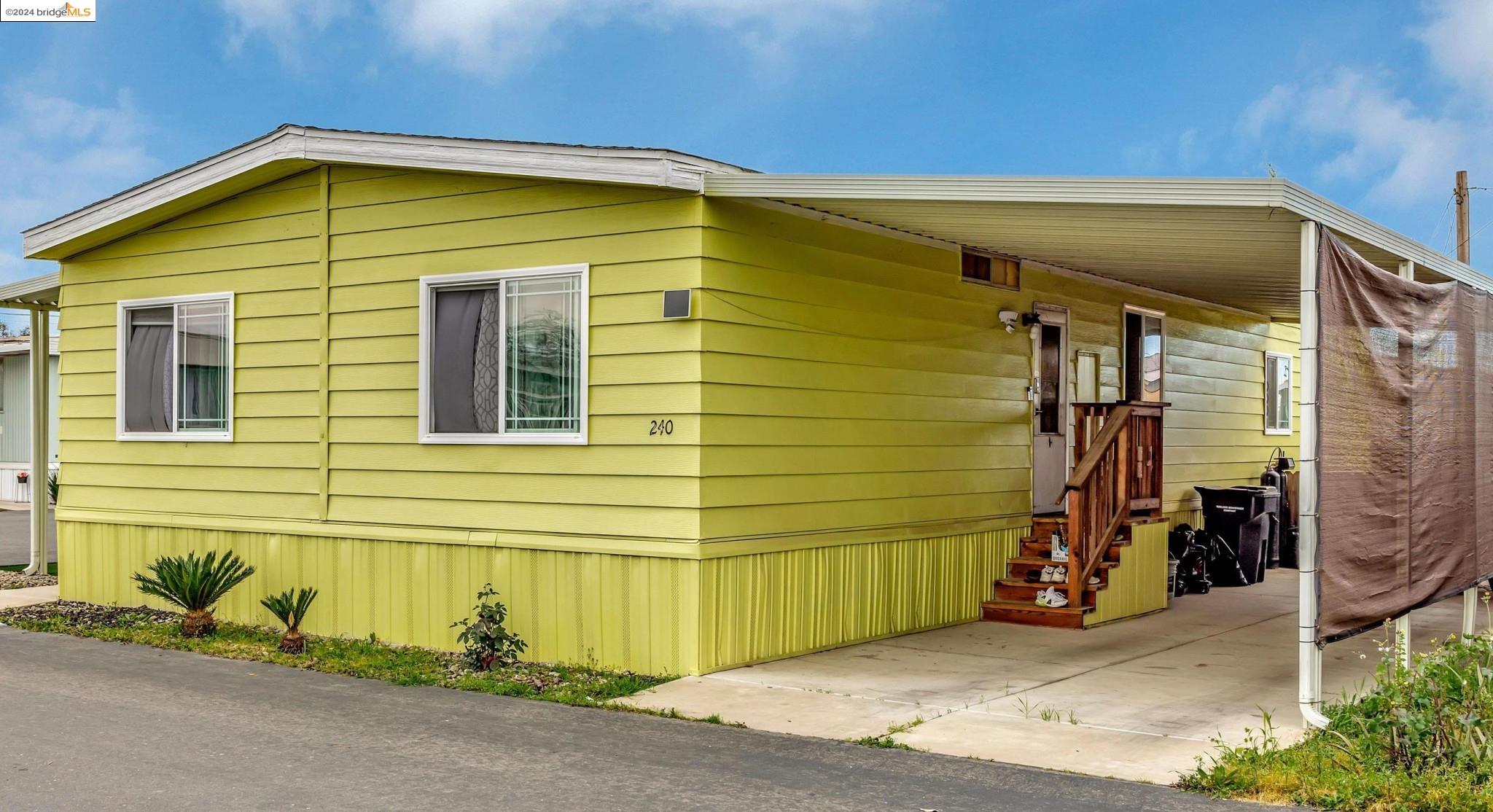 8200 Jantzen Road, Unit 240 Modesto, CA 95357 - Photo 1 of 1 a blue house with outdoor space