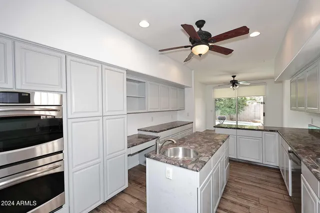 a kitchen with stainless steel appliances granite countertop a stove and a refrigerator