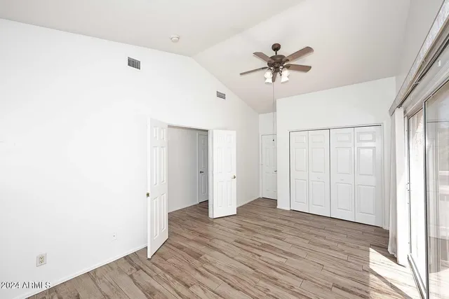 a view of a livingroom with a ceiling fan and wooden floor