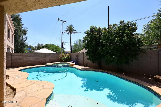 a backyard of a house with table and chairs