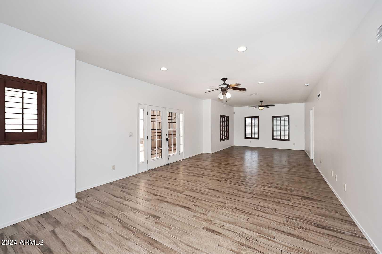 6006 North 5th Place Phoenix, AZ 85014 - Photo 6 of 34 a view of an empty room with wooden floor and a window