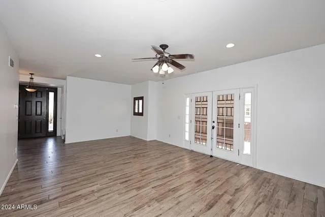 wooden floor in an empty room with a window