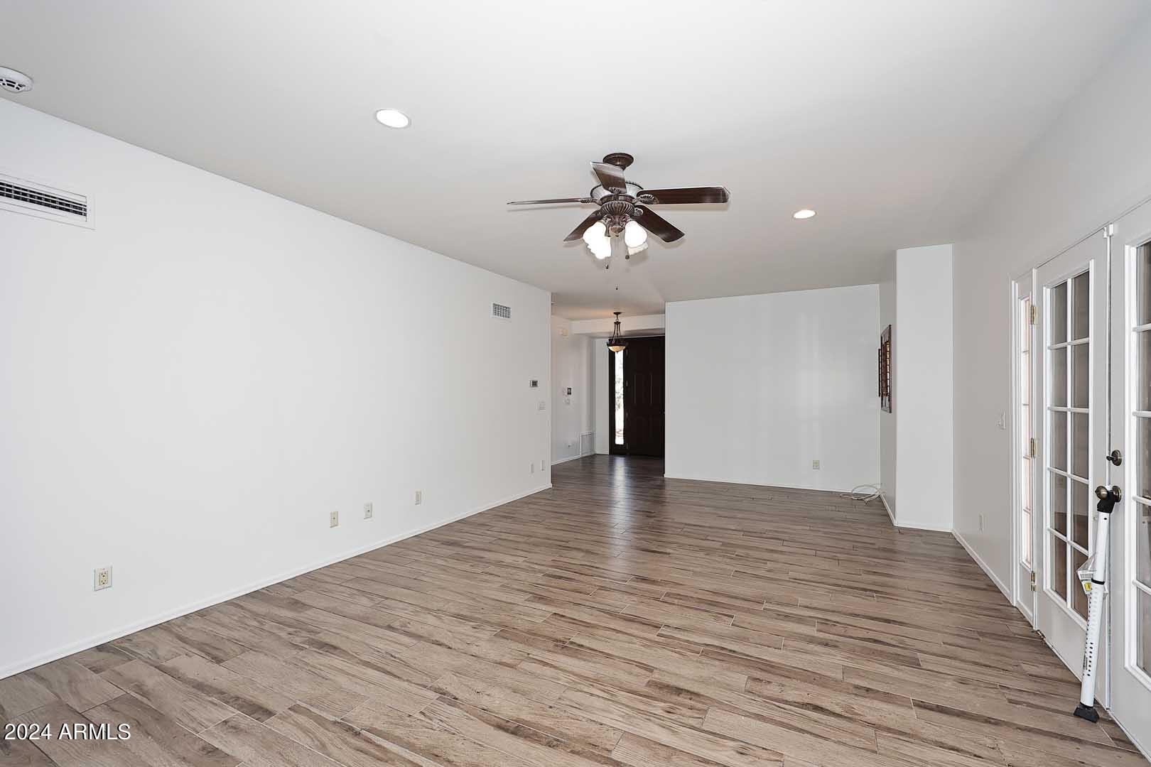 6006 North 5th Place Phoenix, AZ 85014 - Photo 8 of 34 a view of an empty room with wooden floor