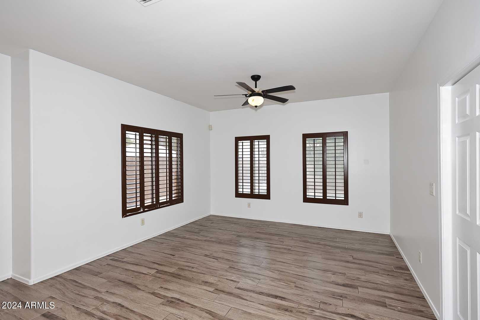 6006 North 5th Place Phoenix, AZ 85014 - Photo 10 of 34 a view of an empty room with a window and wooden floor