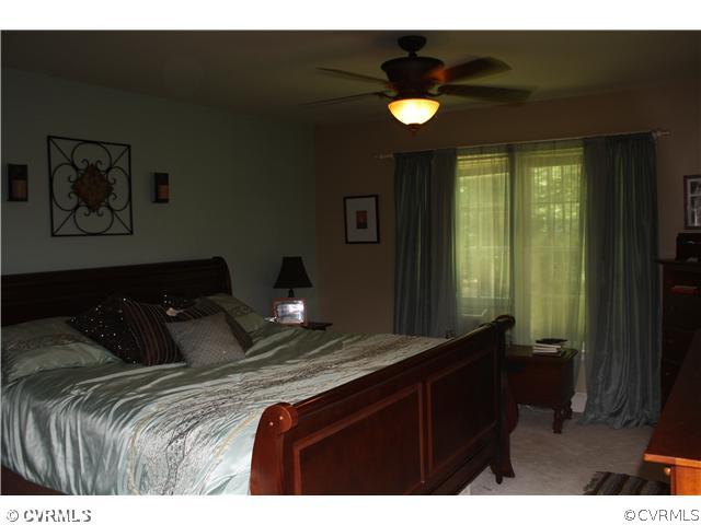 14720 Swift Water Road Chesterfield, VA 23838 - Photo 7 of 12 a bedroom with a bed and a painting on the wall