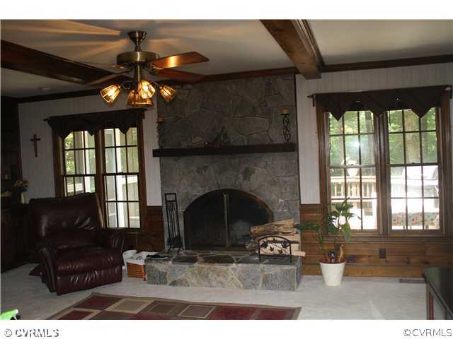 14720 Swift Water Road Chesterfield, VA 23838 - Photo 8 of 12 a living room with furniture a chandelier and a fireplace