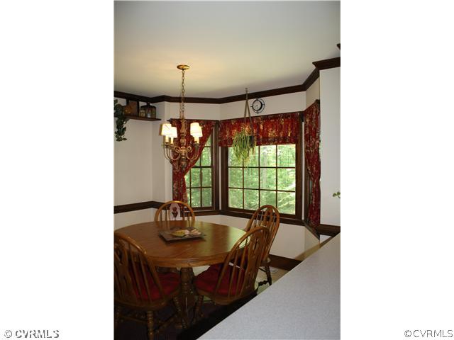 14720 Swift Water Road Chesterfield, VA 23838 - Photo 10 of 12 a view of a dining room with a table and chairs