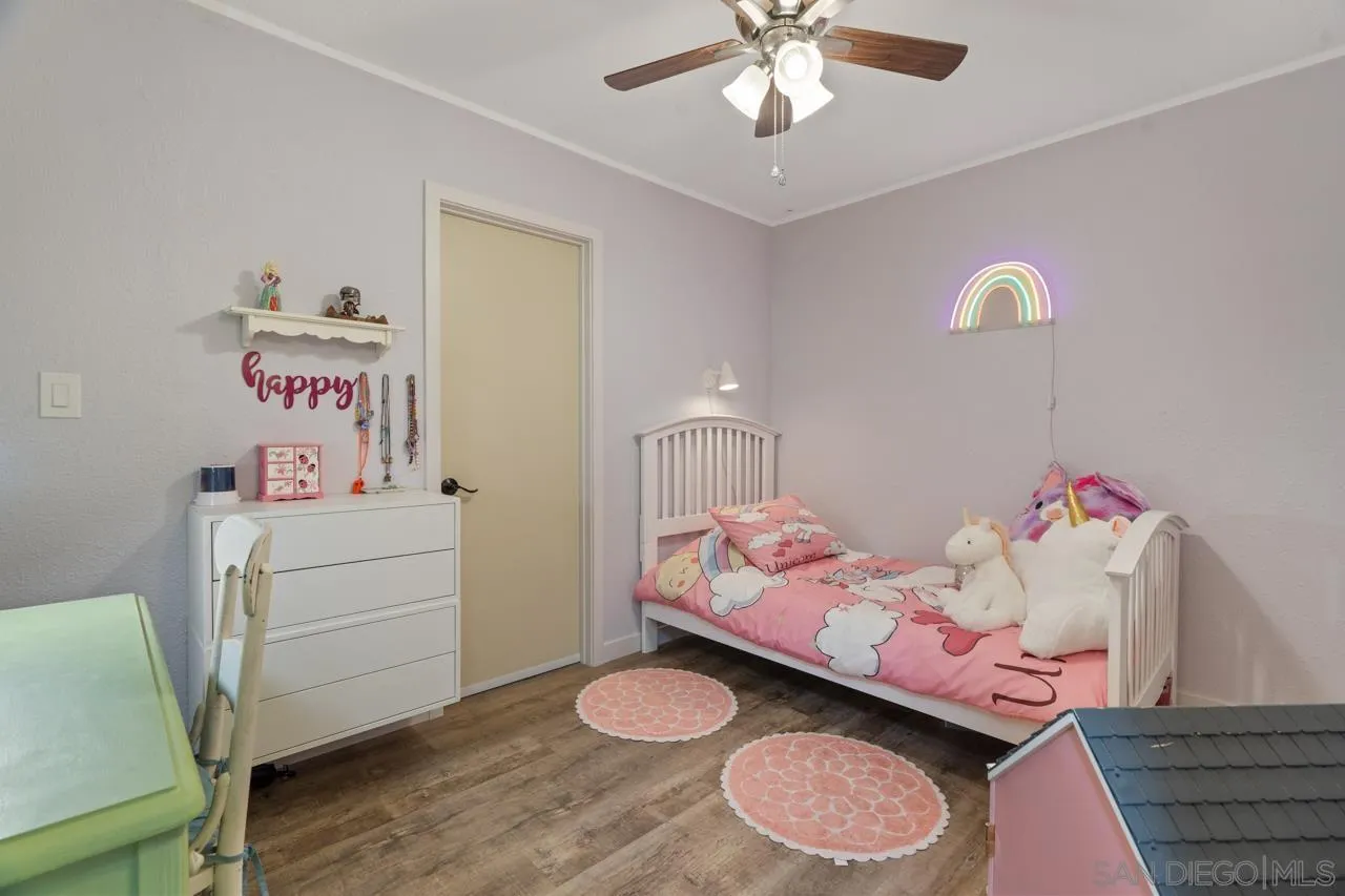 497 Mountain View Road El Cajon, CA 92021 - Photo 11 of 30 a bedroom with a bed and wooden floor